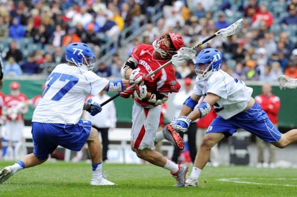 May 25, 2013; Philadelphia, PA, USA; Cornell Big Red midfielder Max Van Bourgondien (center) is double teamed by Duke Blue Devils defenseman Henry Lobb (77) and midfielder David Lawson (right) during the first quarter of the 2013 NCAA Division I men's lacrosse semifinals at Lincoln Financial Field.  Mandatory Credit: Rich Barnes-USA TODAY Sports